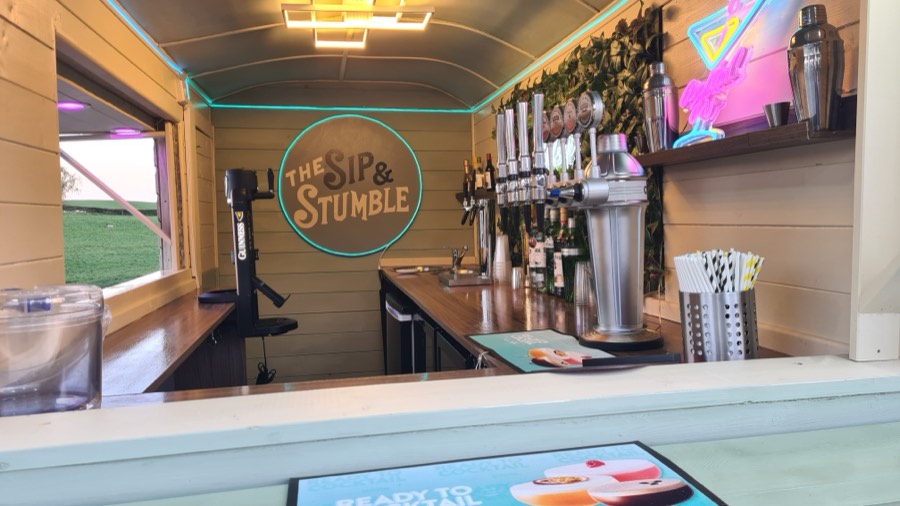 Inside the Sip & Stumble horsebox bar with draught taps