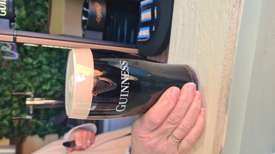 A pint of Guinness being poured at the bar