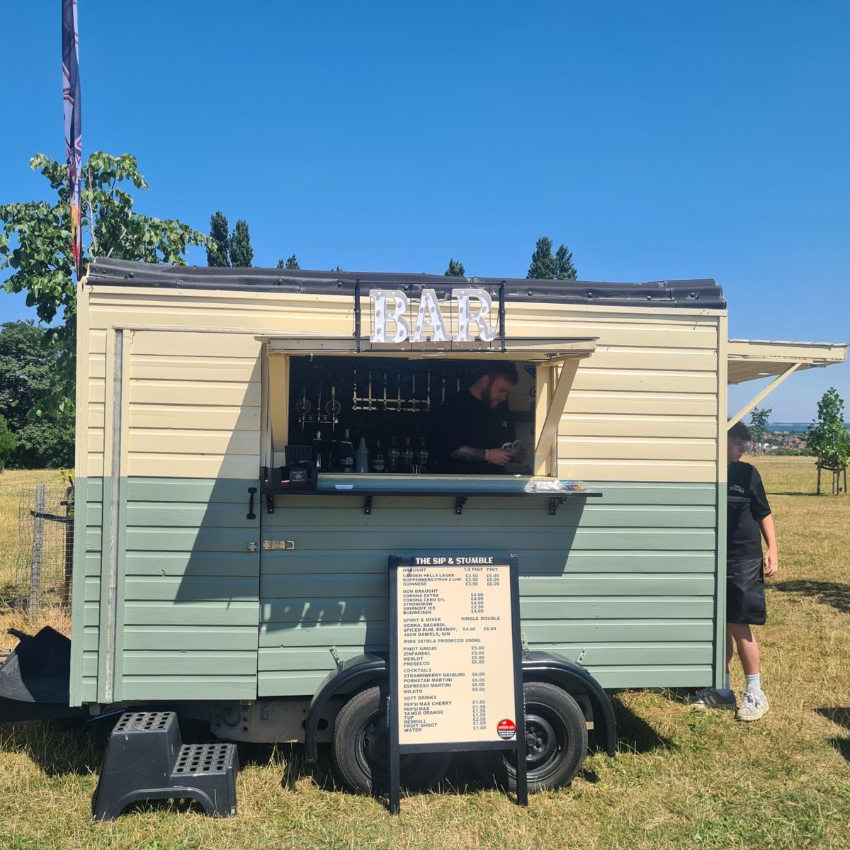 The Sip & Stumble bar serving at a summer event